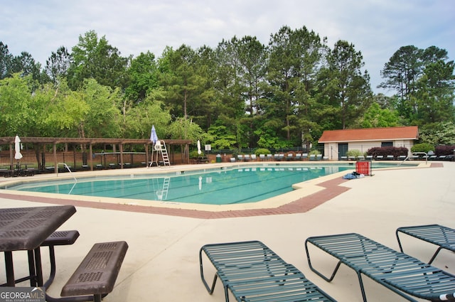 pool featuring a patio area and fence