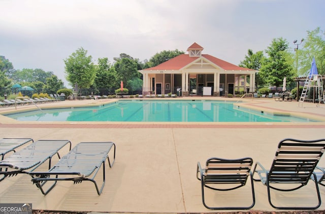 pool featuring a patio area and fence