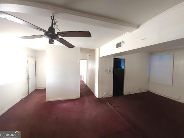 unfurnished room with visible vents, a ceiling fan, and carpet