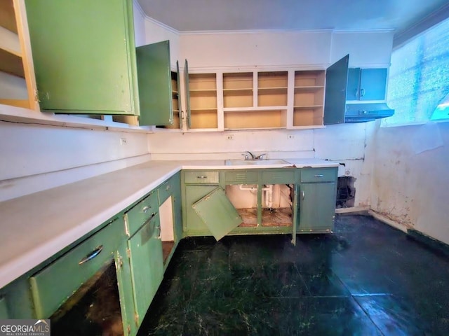 kitchen with open shelves, green cabinets, light countertops, and a sink