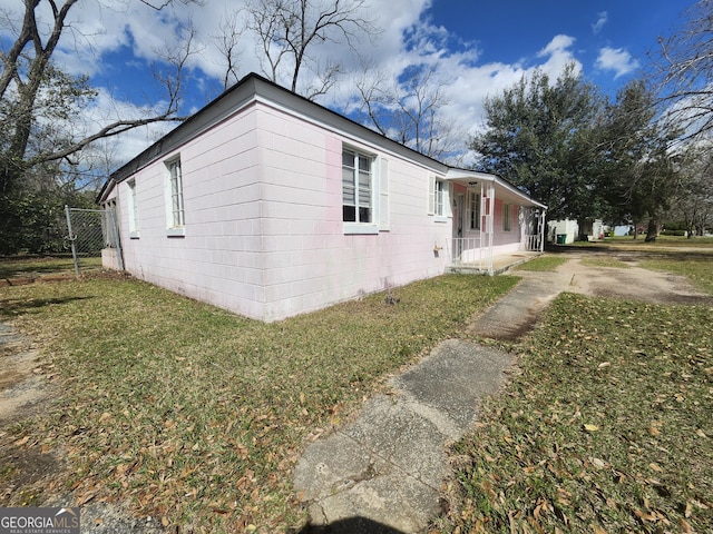 view of side of property with a yard