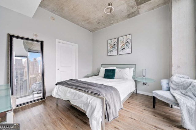 bedroom featuring baseboards and wood finished floors