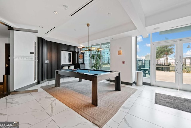 game room featuring french doors, a raised ceiling, marble finish floor, and billiards