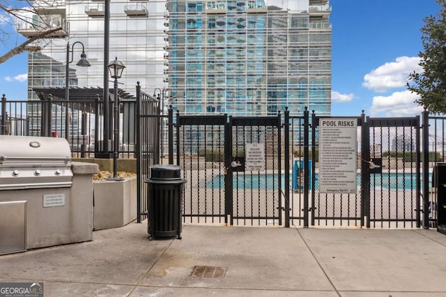 view of patio / terrace with fence and a gate