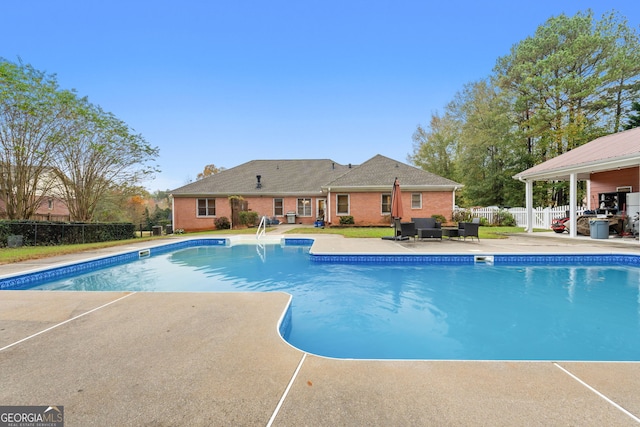 view of swimming pool with a fenced in pool, a patio, and fence