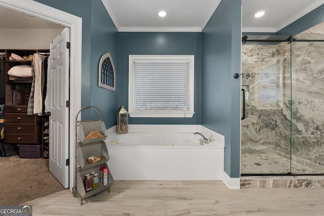 full bathroom featuring a shower stall, a walk in closet, crown molding, a garden tub, and recessed lighting