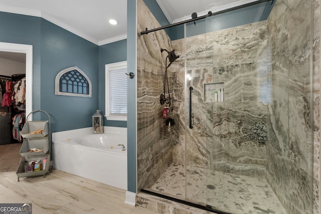 full bathroom featuring crown molding, a spacious closet, a garden tub, and a shower stall