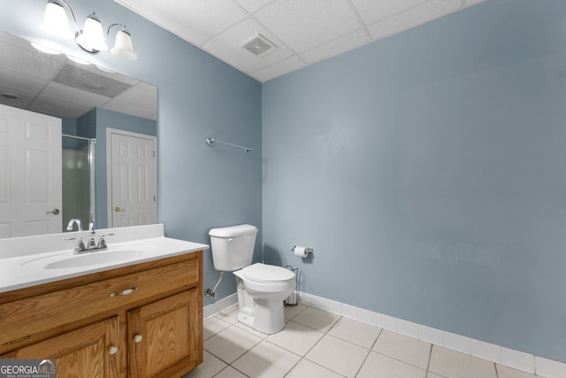 bathroom featuring visible vents, an enclosed shower, toilet, a drop ceiling, and tile patterned flooring