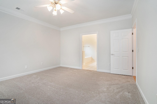 unfurnished bedroom featuring light carpet, visible vents, crown molding, and baseboards