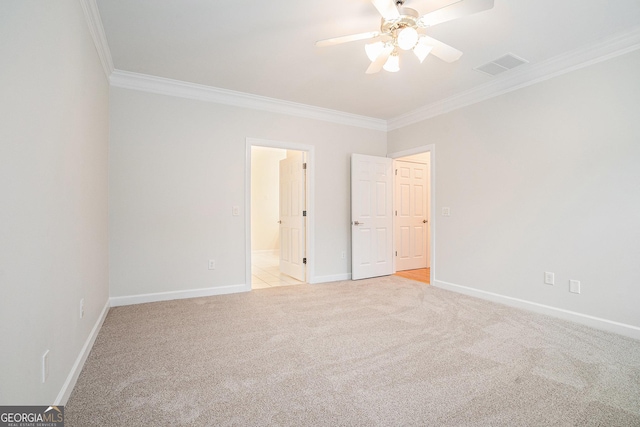 unfurnished bedroom with visible vents, baseboards, crown molding, light colored carpet, and connected bathroom