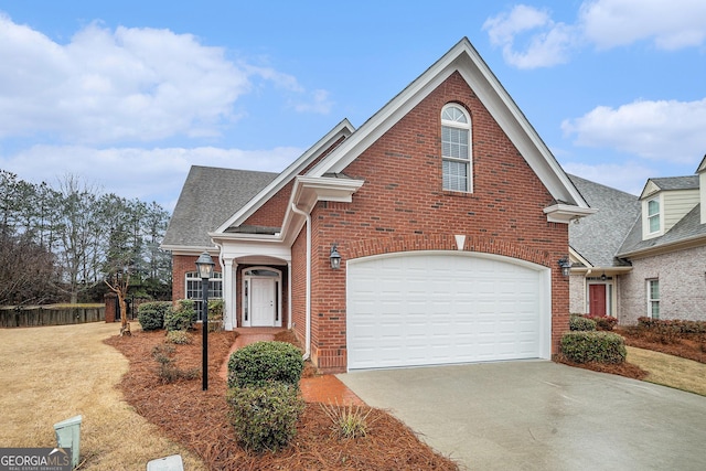 traditional home featuring brick siding, concrete driveway, a garage, and roof with shingles