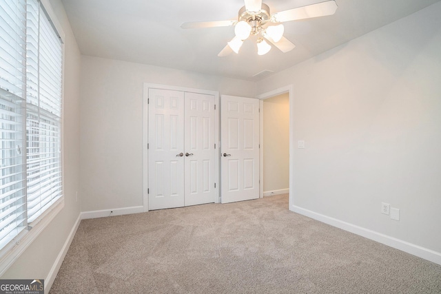 unfurnished bedroom featuring visible vents, baseboards, a closet, and carpet flooring