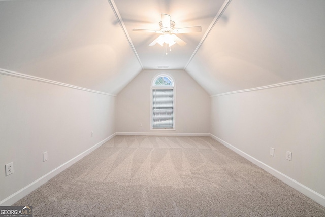 bonus room with ceiling fan, baseboards, lofted ceiling, and carpet floors