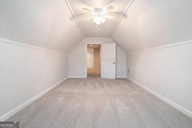 additional living space featuring visible vents, baseboards, ceiling fan, lofted ceiling, and carpet floors