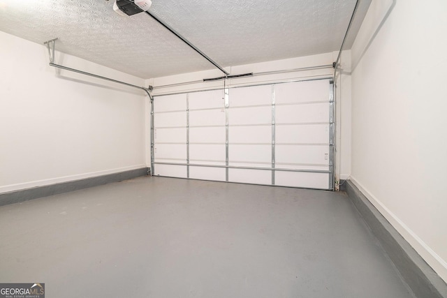 garage featuring a garage door opener and baseboards