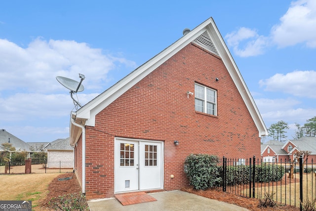 back of house with fence and brick siding