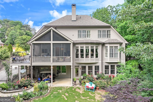 3845 Starboard Pt, Gainesville, GA 30506 - back of property featuring a patio, a chimney, a sunroom, a lawn, and roof with shingles