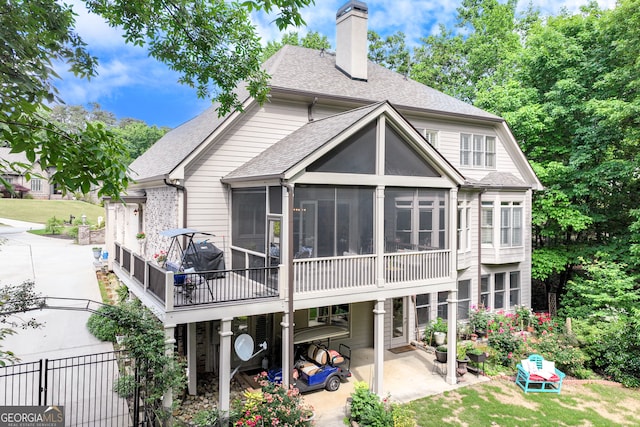 3845 Starboard Pt, Gainesville, GA 30506 - rear view of house with a patio area, a sunroom, a chimney, a shingled roof, and fence
