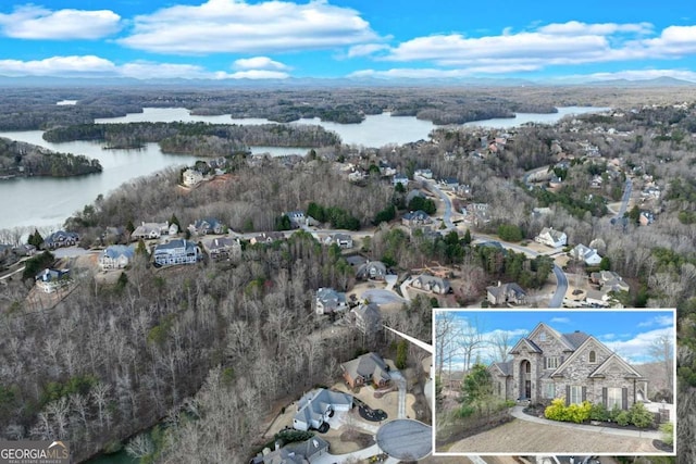 aerial view featuring a view of trees and a water view