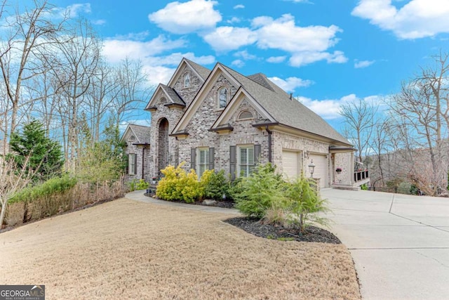 view of front of property with a garage, brick siding, roof with shingles, and concrete driveway