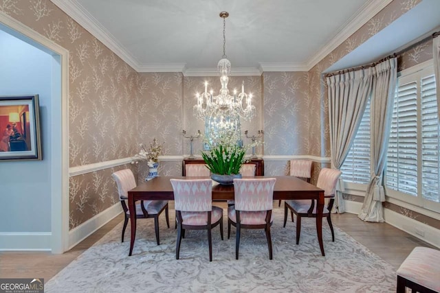 dining room featuring wallpapered walls, wood finished floors, baseboards, and a chandelier