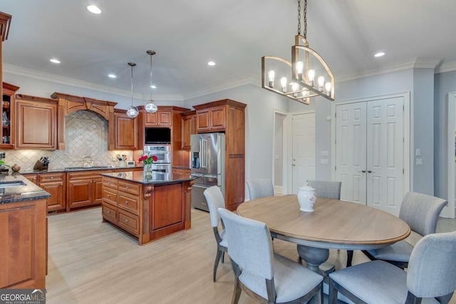 kitchen featuring brown cabinets, a center island, light wood-style floors, high quality fridge, and decorative backsplash