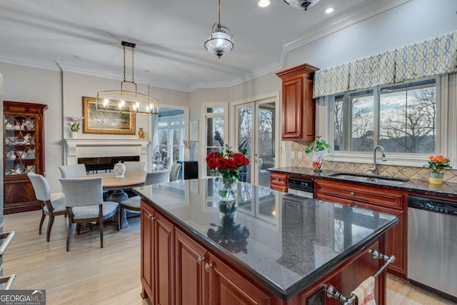 kitchen with a sink, french doors, stainless steel dishwasher, crown molding, and backsplash