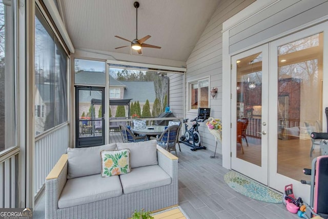 sunroom / solarium featuring french doors, a ceiling fan, and lofted ceiling