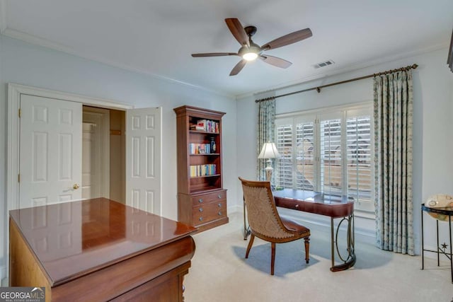 office area with light carpet, visible vents, a ceiling fan, and ornamental molding