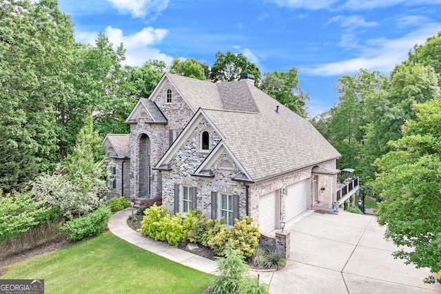 3845 Starboard Pt, Gainesville, GA 30506 - french country inspired facade with brick siding, concrete driveway, a shingled roof, a chimney, and a front lawn