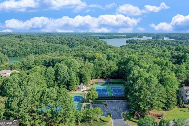 birds eye view of property featuring a wooded view and a water view