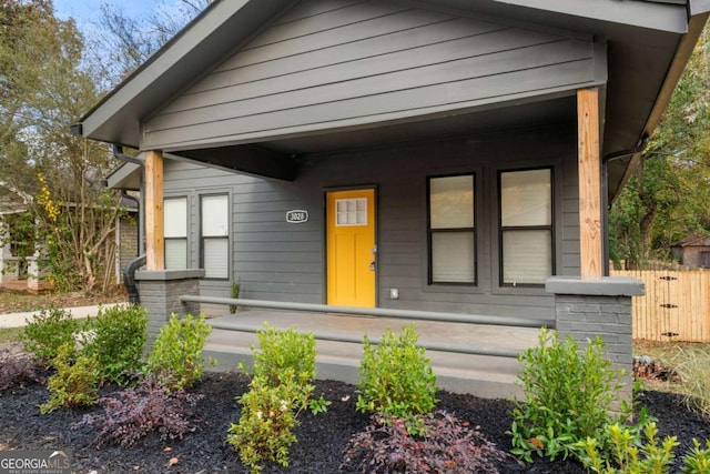 view of front of house with a porch and fence