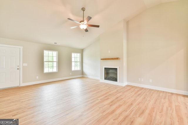 unfurnished living room featuring a glass covered fireplace, ceiling fan, and wood finished floors