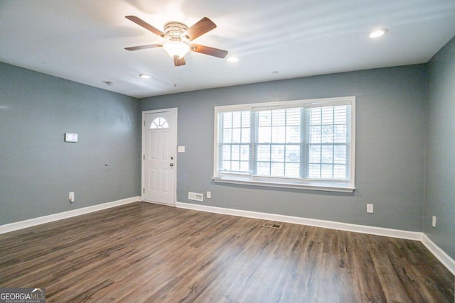 entrance foyer with dark wood finished floors, visible vents, a ceiling fan, and baseboards