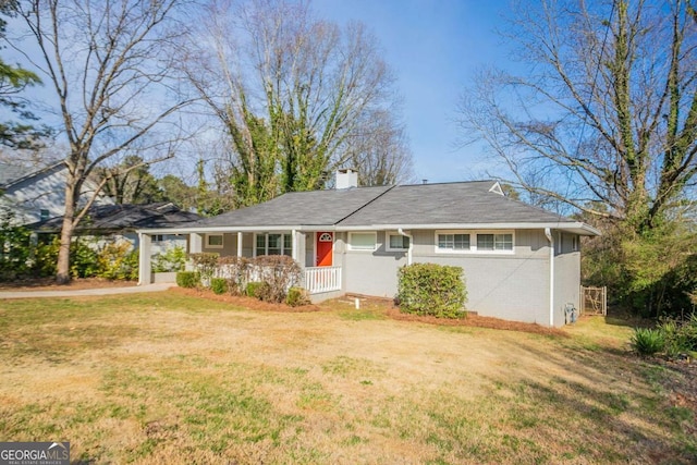 single story home with brick siding, a chimney, a front lawn, and dirt driveway