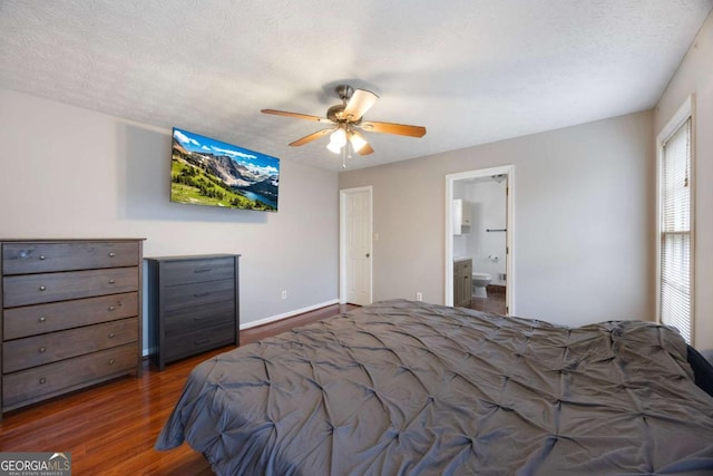 bedroom featuring a ceiling fan, a textured ceiling, wood finished floors, connected bathroom, and baseboards