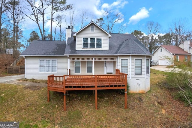 back of house with a shingled roof and a chimney