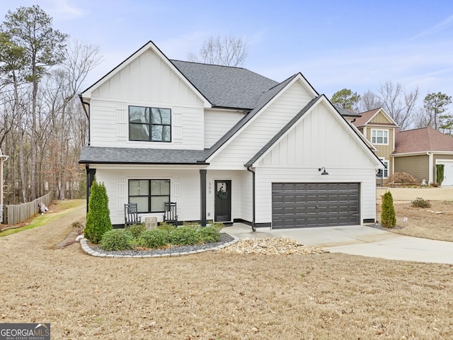 modern inspired farmhouse with concrete driveway, covered porch, board and batten siding, and a shingled roof