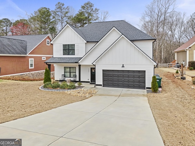 modern inspired farmhouse featuring driveway, roof with shingles, an attached garage, covered porch, and board and batten siding