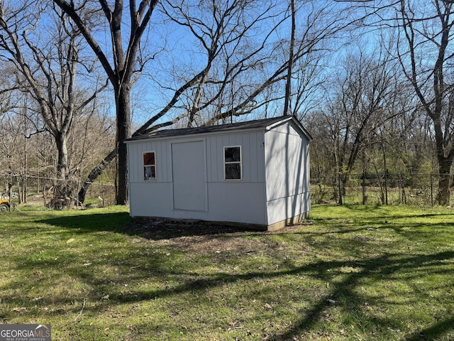 view of shed featuring fence