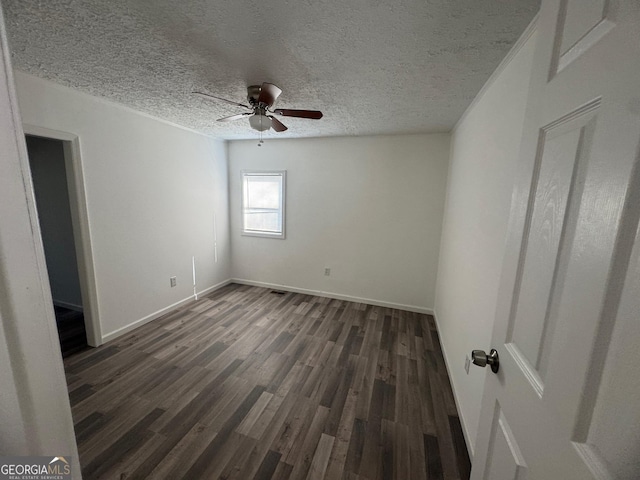 unfurnished room with baseboards, a textured ceiling, dark wood finished floors, and a ceiling fan