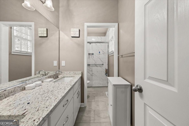 bathroom with vanity, a shower stall, toilet, and marble finish floor