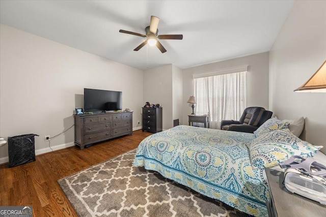 bedroom featuring a ceiling fan, wood finished floors, and baseboards