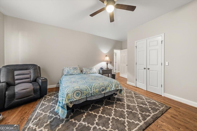 bedroom with ceiling fan, baseboards, and wood finished floors