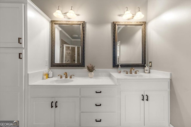 bathroom featuring double vanity, a stall shower, and a sink