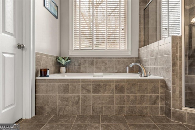 full bathroom with tiled shower and a garden tub