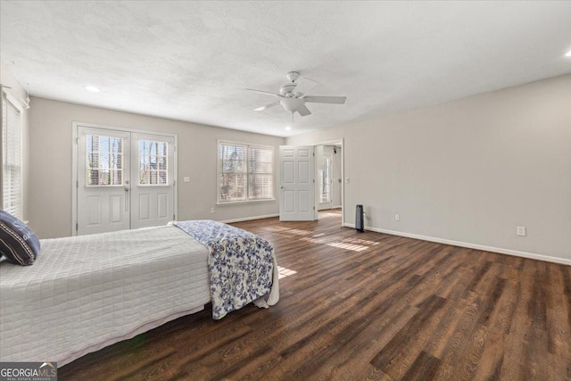 bedroom with a ceiling fan, wood finished floors, and baseboards