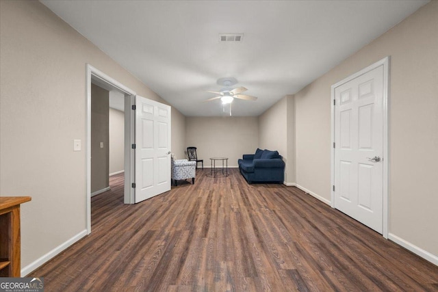 unfurnished room featuring visible vents, wood finished floors, and baseboards