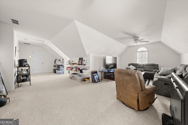 carpeted living room featuring visible vents and vaulted ceiling