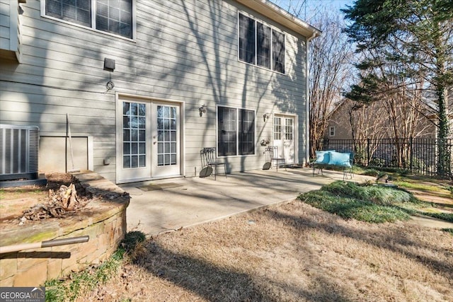 back of house featuring french doors, a patio, central AC, and fence